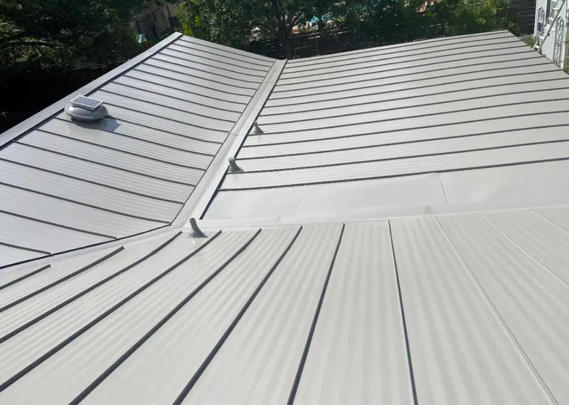Solar attic fan installed on a metal roof for Roof Ventilation in Storm Lake